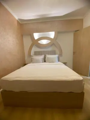 a bedroom with a large white bed with a window at CC Luxurious Apartment in Hurghada