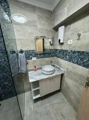 a bathroom with a shower and a sink and a toilet at CC Luxurious Apartment in Hurghada