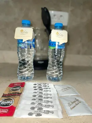 two bottles of water sitting on top of a table at CC Luxurious Apartment in Hurghada