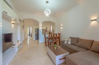a living room with a couch and a table at Cozy apartment with a pool in South Marina-Elgouna in Hurghada
