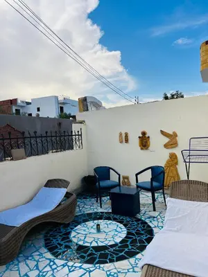 a patio with chairs and a table on a balcony at private home lucky seven in Luxor