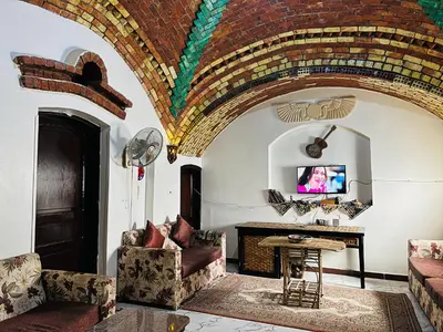 a living room with a couch and a table at private home lucky seven in Luxor