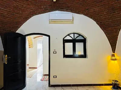 an archway with a black door and a window at private home lucky seven in Luxor