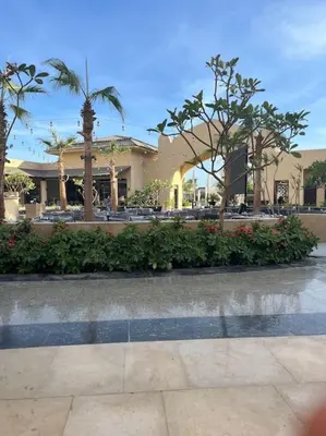 a resort with palm trees and a building at Hula Hula piece of the sea in Hurghada