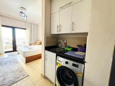 a kitchen with a washer and dryer in a room at Hula Hula piece of the sea in Hurghada