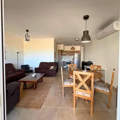 a living room with a couch and a table at Somabay Breezy Elegance 3BR Apartment in Hurghada