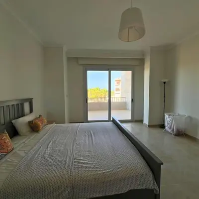 a bedroom with a large bed with a large window at Somabay Breezy Elegance 3BR Apartment in Hurghada