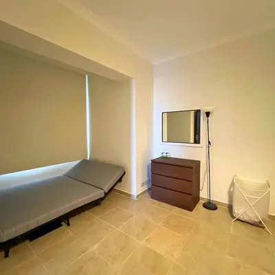 a bedroom with a bed and a dresser and a mirror at Somabay Breezy Elegance 3BR Apartment in Hurghada