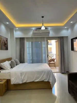 a bedroom with a large bed and a couch at Juliana Beach Aqua park in Hurghada