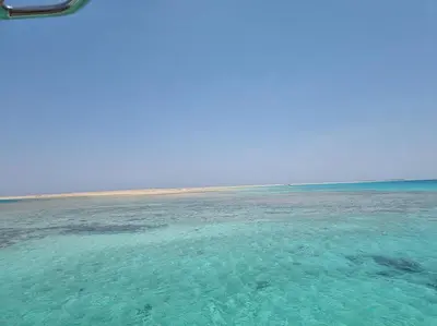 a large body of water with a beach in the background at Camelgila Appartment Royal Residence in Port Ghalib