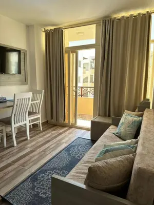 a living room with a couch and a table at Camelgila Appartment Royal Residence in Port Ghalib
