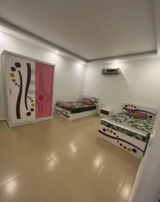 a room with two beds in it with lights at Two Bedroom Apartment in Lilly Land in Hurghada