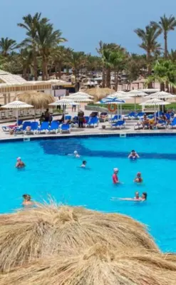 a group of people swimming in a large swimming pool at Two Bedroom Apartment in Lilly Land in Hurghada