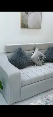a white couch with pillows on it in a living room at Juliana beach in Hurghada