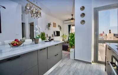 a kitchen with a counter with a bowl of fruit on it at Lavish suite 97m wifi sea view apt boutique resort in Hurghada
