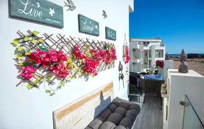a white building with flowers on a wall at Lavish suite 97m wifi sea view apt boutique resort in Hurghada