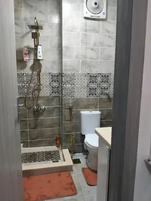a bathroom with a shower and a toilet at Petite Perle in Port Ghalib