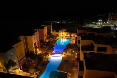 an overhead view of a swimming pool at night at Al Dora Resort All Inclusive Hotel in Hurghada