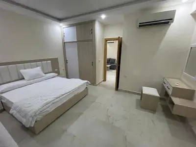 a bedroom with a bed and a sink and a mirror at قرية ميراج باي in Hurghada