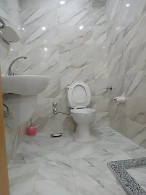 a white bathroom with a toilet and a sink at قرية ميراج باي in Hurghada