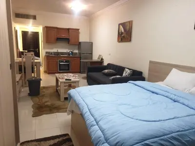 a bedroom with a bed and a living room at Studil for rent old Sheraton 205 in Hurghada