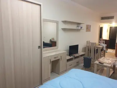 a bedroom with a bed and a mirror and a desk at Studil for rent old Sheraton 205 in Hurghada