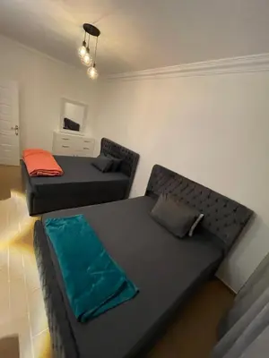 a living room with two beds and a couch at Sea view apartment 10 , in city center front of the sea F 10 in Hurghada