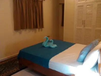 a bedroom with two blue swans on a bed at Desert Rose Apartment in Hurghada