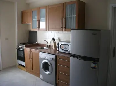 a kitchen with a refrigerator and a washing machine at Desert Rose Apartment in Hurghada