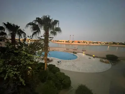 a swimming pool with a palm tree in the water at El gouna , Red sea in Hurghada