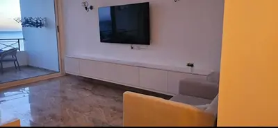 a living room with a television on a wall at Sea view apartment 09 , in city center in front off the sea 09 in Hurghada
