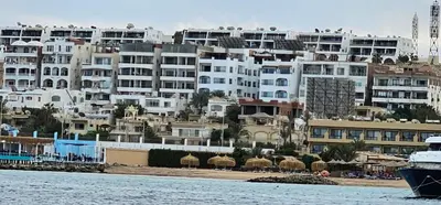 a group of buildings on the shore of a beach at Sea view apartment 09 , in city center in front off the sea 09 in Hurghada