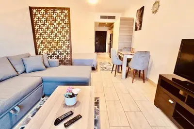 a living room with a couch and a tv at Bosha Aldau Heights Hurghada rent studio in Hurghada