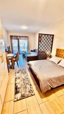 a bedroom with a bed and a table and a desk at Bosha Aldau Heights Hurghada rent studio in Hurghada