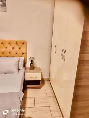 a small bedroom with a bed and a mirror at Bosha Aldau Heights Hurghada rent studio in Hurghada