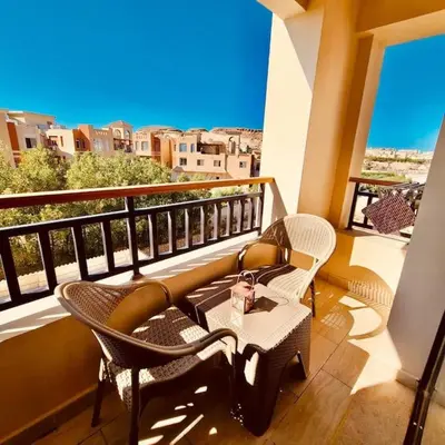 a balcony with chairs and a table on a balcony at Bosha Aldau Heights Hurghada rent studio in Hurghada