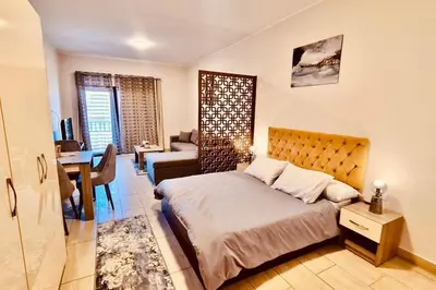 a bedroom with a bed and a living room at Bosha Aldau Heights Hurghada rent studio in Hurghada