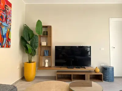 a living room with a flat screen tv on a table at Unique 2BR Villa - Private Pool In Bali-ElGouna in El Gouna