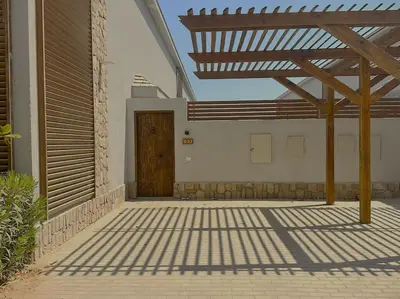 a wooden entrance to a building with a wooden door at Unique 2BR Villa - Private Pool In Bali-ElGouna in El Gouna