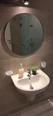 a bathroom sink with a mirror and a soap dispenser at Cozy 1BR in Princess Resort with Pools & Private Beach in Hurghada