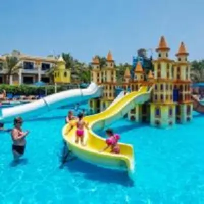 a group of people on a water slide at a water park at Mirage Bay Mina Land Resort & Aquapark in Hurghada
