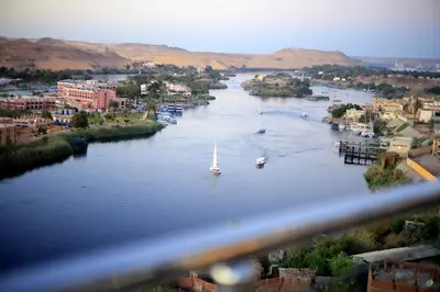 a view of a river with a boat in it at Blue Lotus Nile Suites Hotel Aswan in Aswan