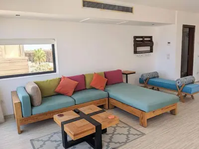 a living room with a couch and a table at Elevated Sea View 2BR Standalone Free Beach & Pool in Somabay in Hurghada