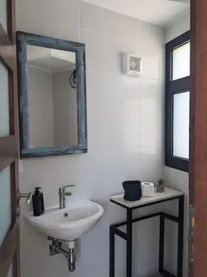 a bathroom with a sink and a mirror at Elevated Sea View 2BR Standalone Free Beach & Pool in Somabay in Hurghada