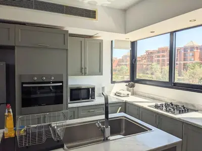 a kitchen with a sink and a microwave at Elevated Sea View 2BR Standalone Free Beach & Pool in Somabay in Hurghada