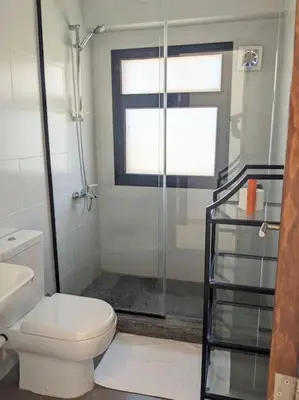 a bathroom with a toilet and a glass shower at Elevated Sea View 2BR Standalone Free Beach & Pool in Somabay in Hurghada