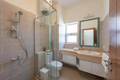 a bathroom with a toilet and a sink and a mirror at Gouna Retreat 2BR Apt Waterside Hot Tub & Pool in Hurghada