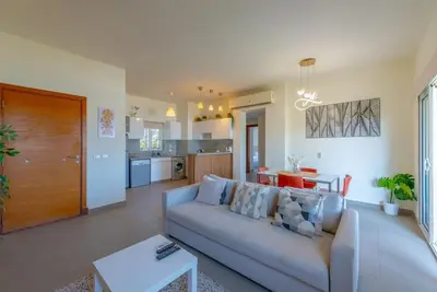 a living room with a couch and a table at Gouna Retreat 2BR Apt Waterside Hot Tub & Pool in Hurghada