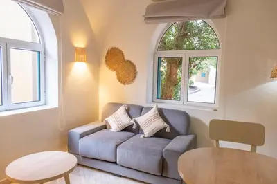 a living room with a couch and two windows at Studio Serenity Downtown El Gouna in Hurghada