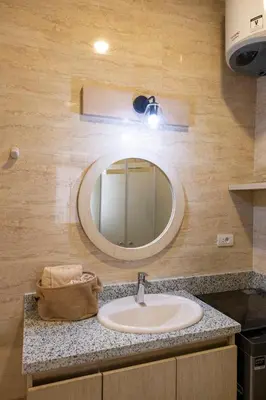 a bathroom with a sink and a mirror at Studio Serenity Downtown El Gouna in Hurghada